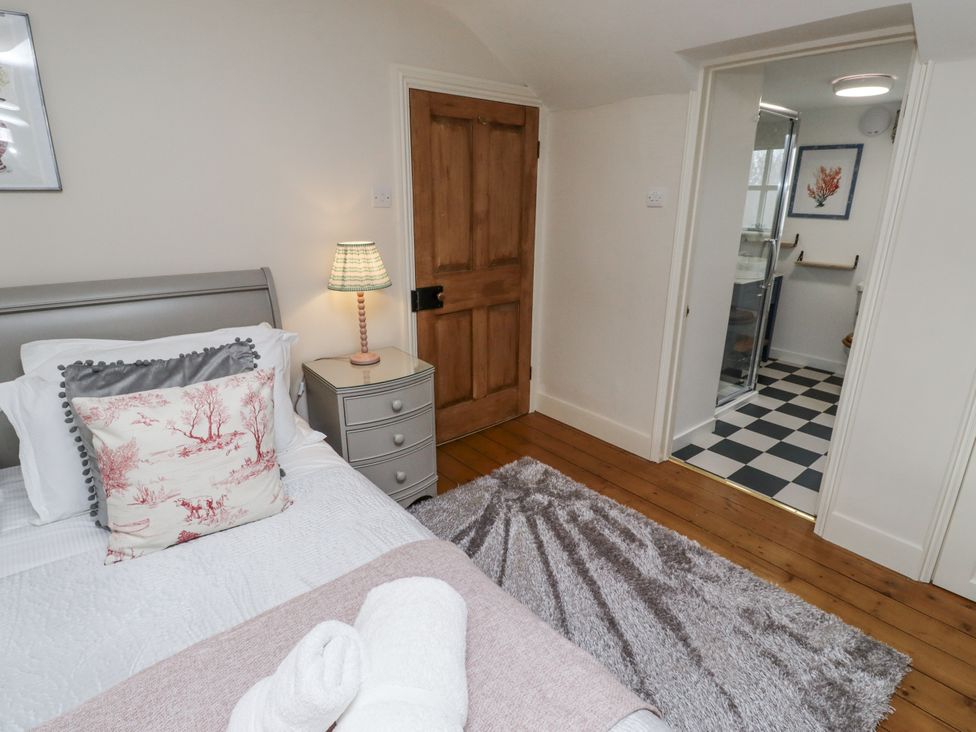 A bedroom with a bed and lamp at Peary House in Alnwick