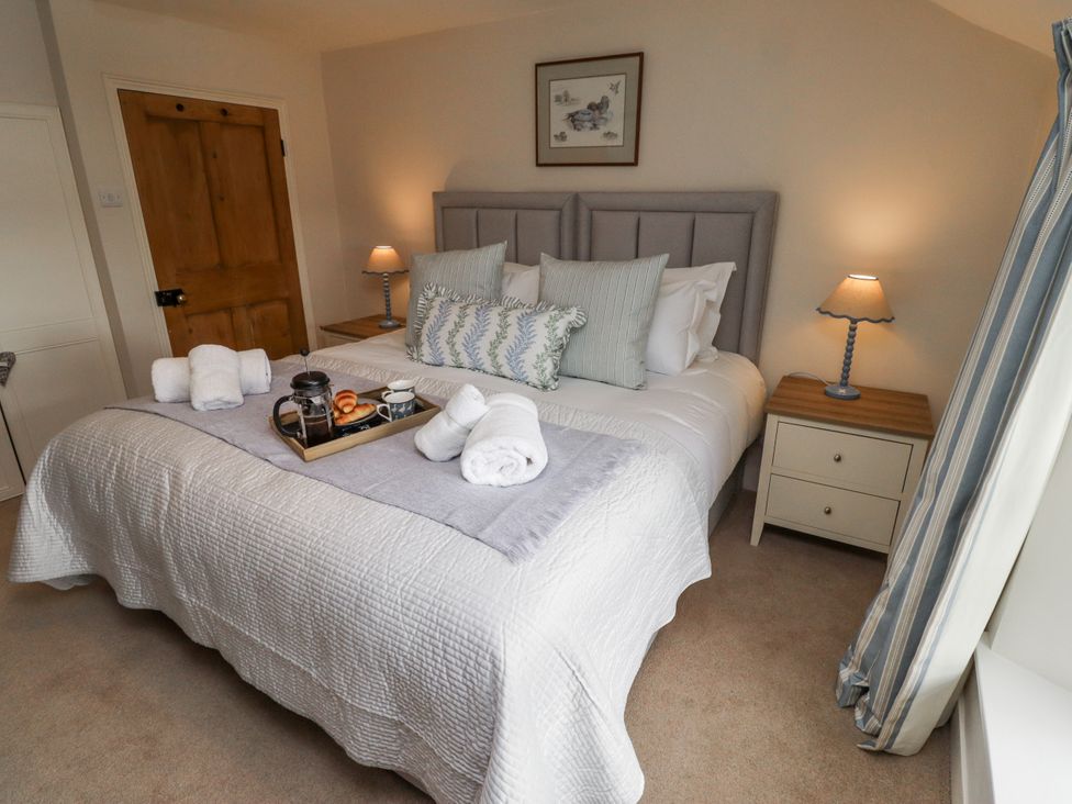 A bedroom with a bed and nightstand at Peary House in Alnwick