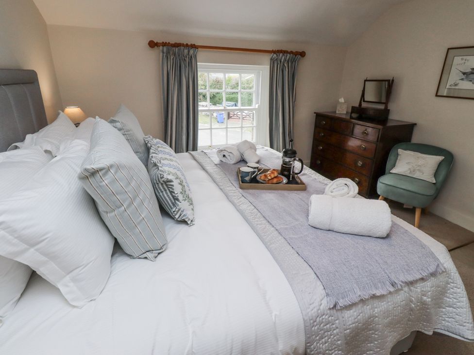 A bedroom with a bed and dresser at Peary House in Alnwick