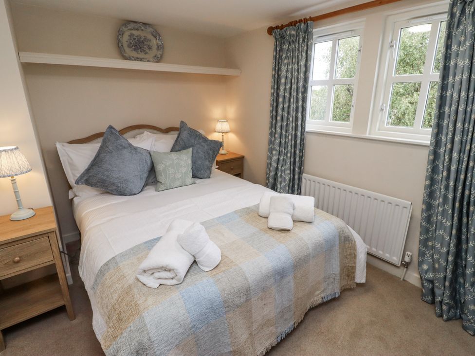 A bedroom with a bed and bedside lamp at Peary House in Alnwick