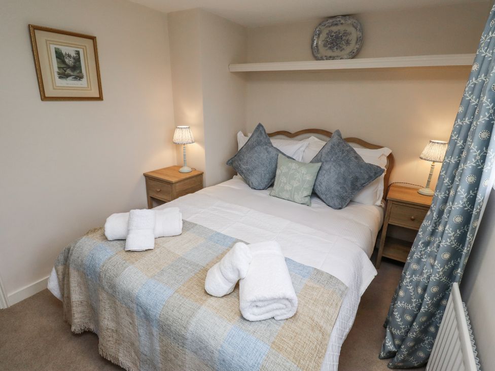 A bedroom with a bed and bedside tables at Peary House in Alnwick