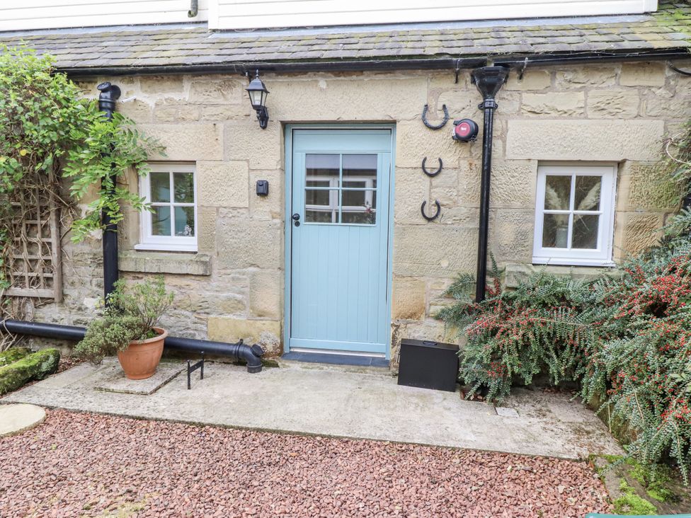 An entrance with a blue door and windows at Peary House in Alnwick
