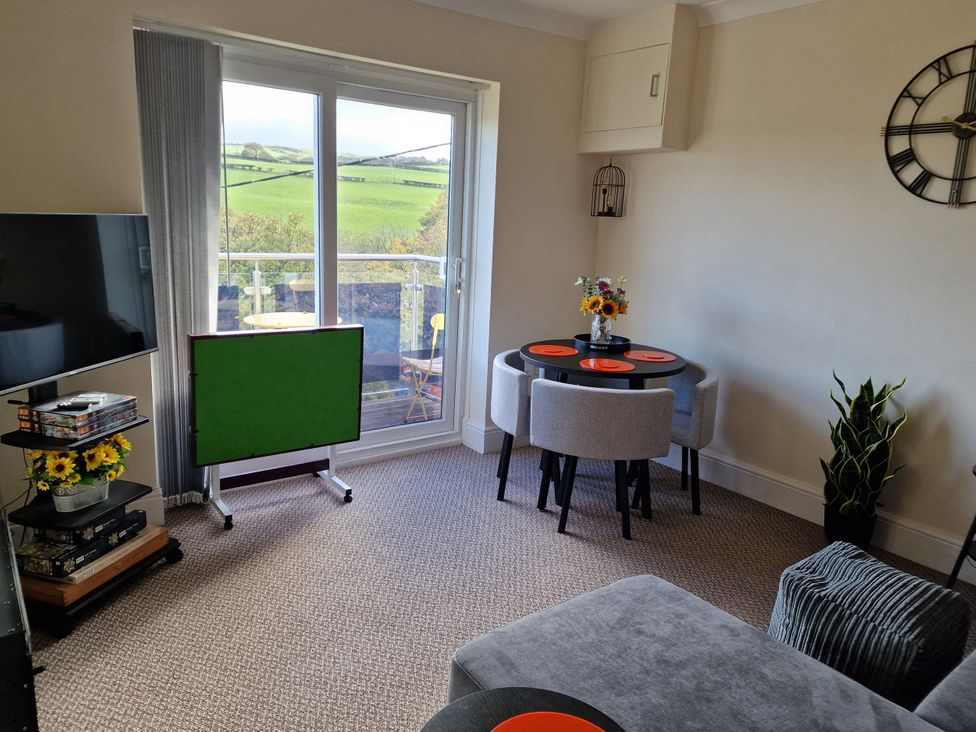A living room with a television and table at Golygfa in Abergele