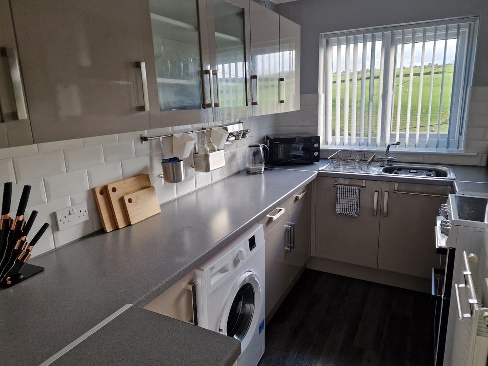 A kitchen with cabinets, countertop, and appliances at Golygfa in Abergele