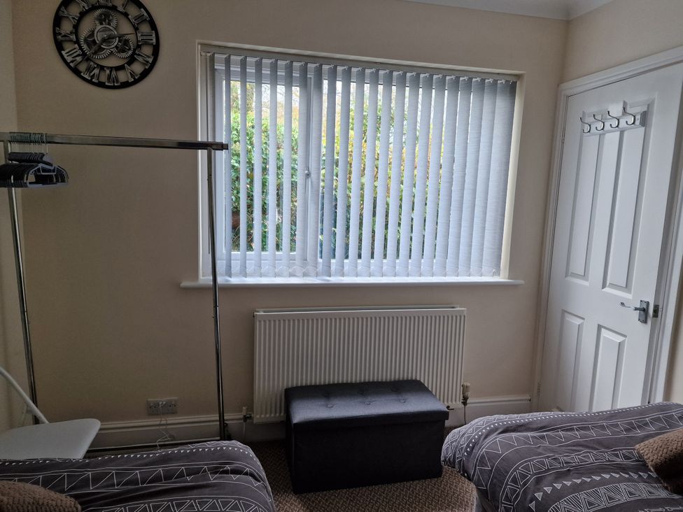A bedroom with a window and radiator at Golygfa Abergele