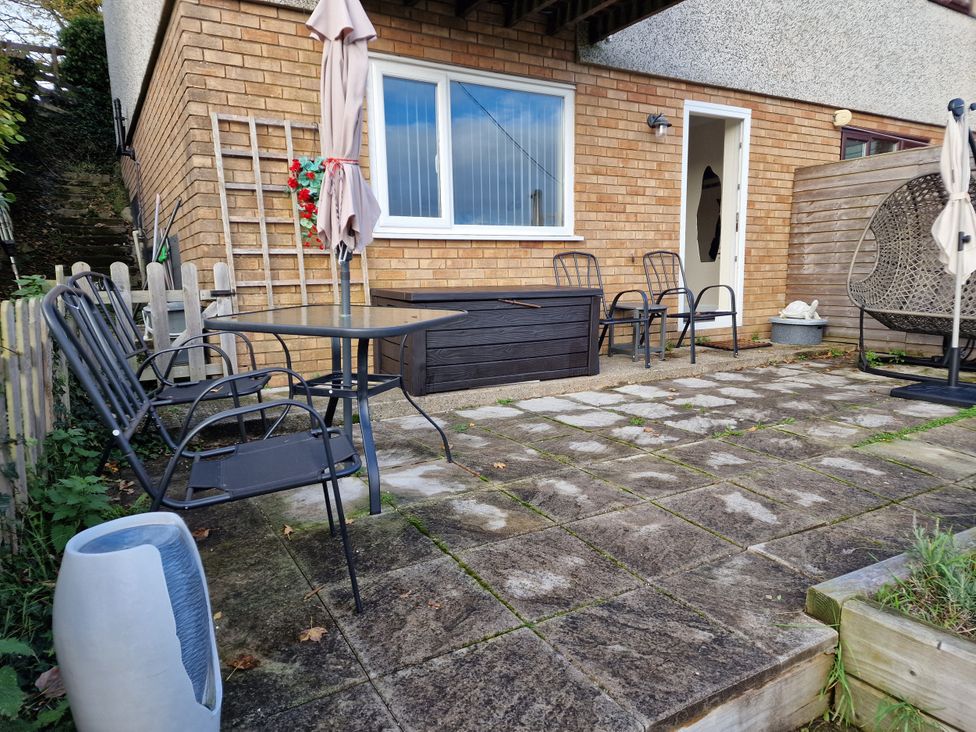 An outdoor patio with table and chairs at Golygfa Abergele