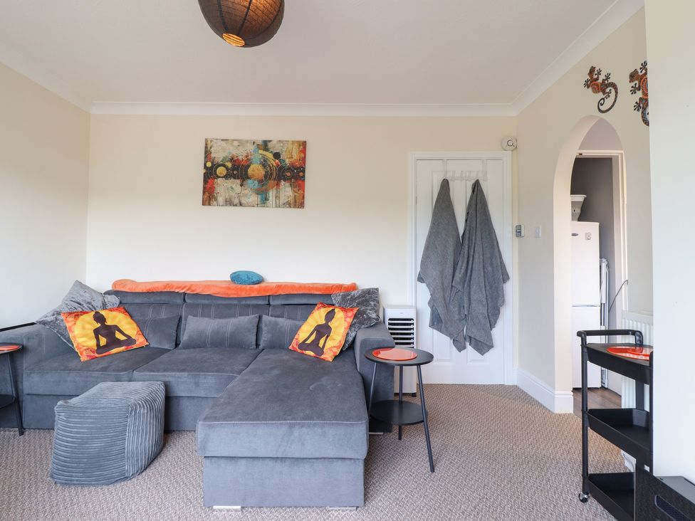 A living room with a sofa and coffee table at Golygfa Pandy Tudur near Llanrwst