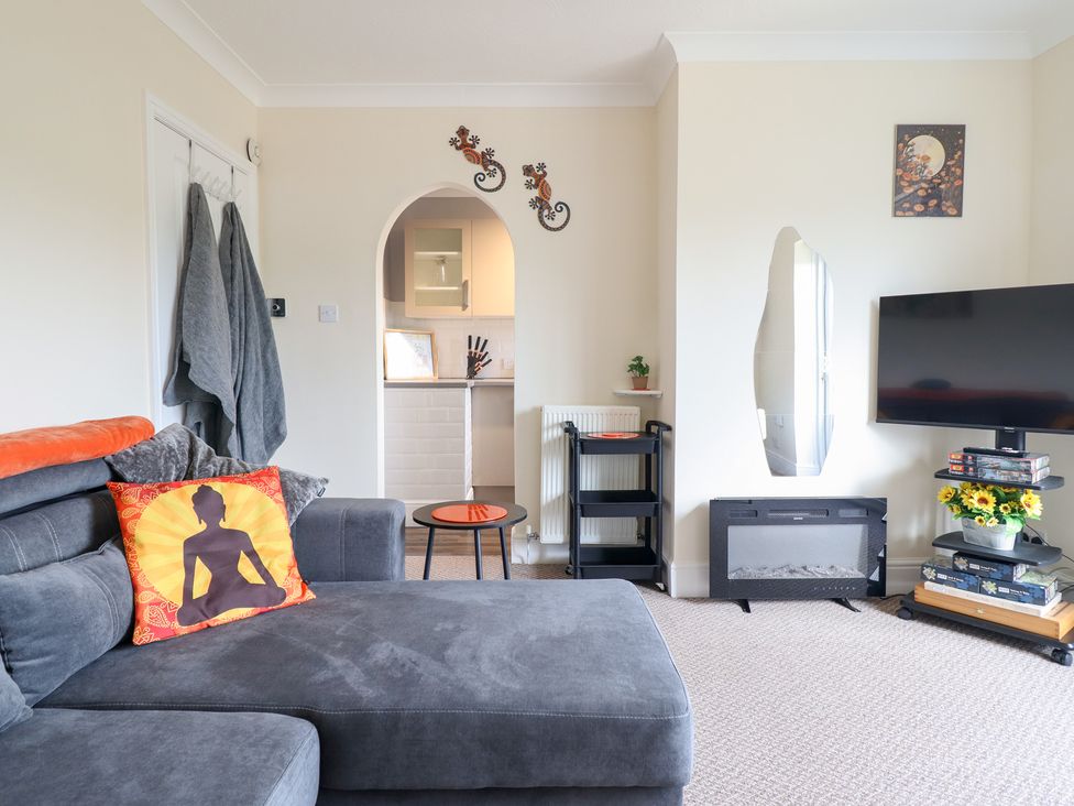 A living room with a sofa and television at Golygfa, Pandy Tudur near Llanrwst