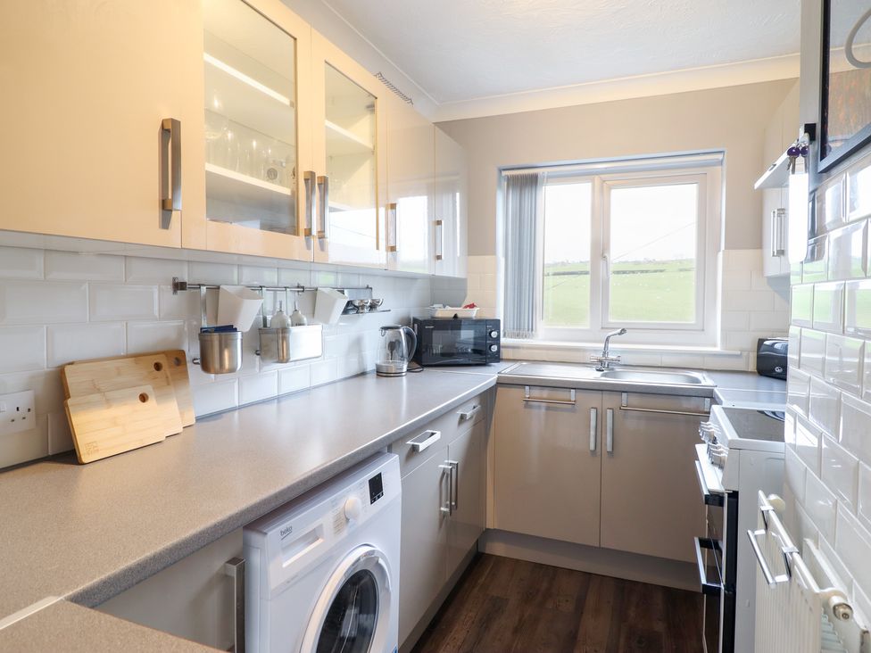 A kitchen with appliances and cabinets at Golygfa in Pandy Tudur near Llanrwst