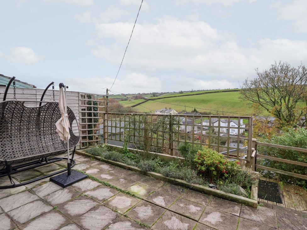A garden with a swing seat and view of hills at Golygfa in Pandy Tudur near Llanrwst