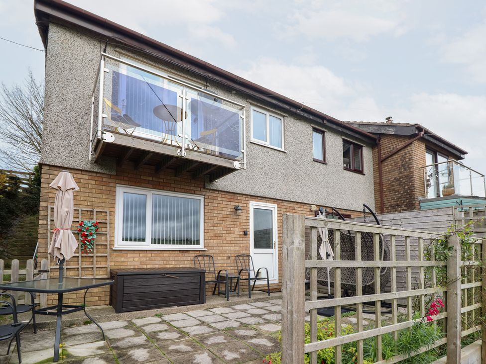 An outdoor area with a balcony and seating at Golygfa in Pandy Tudur near Llanrwst