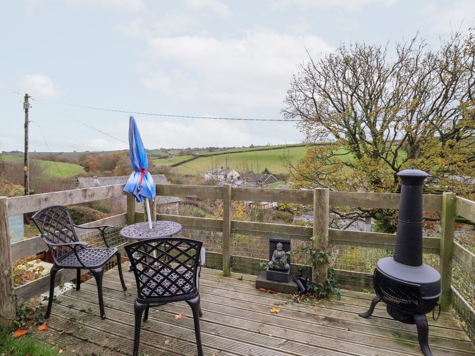 An outdoor area with chairs and a table at Golygfa in Pandy Tudur near Llanrwst