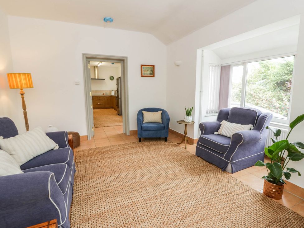 A living room with sofas and a table at Llain in Cardigan