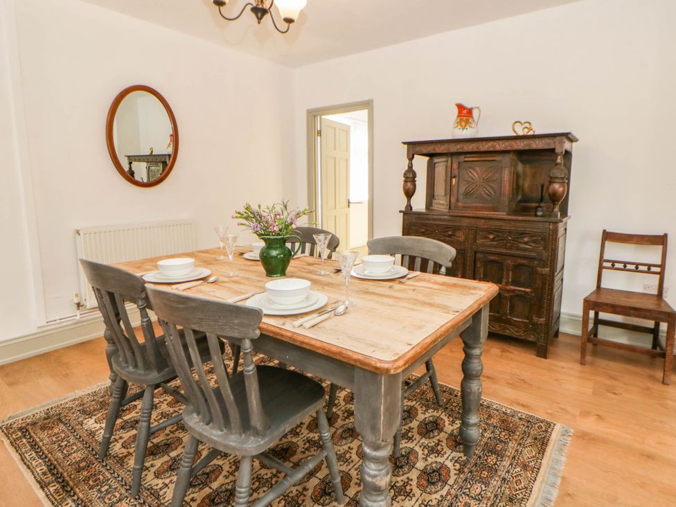 A dining room with a table and chairs at Llain in Cardigan