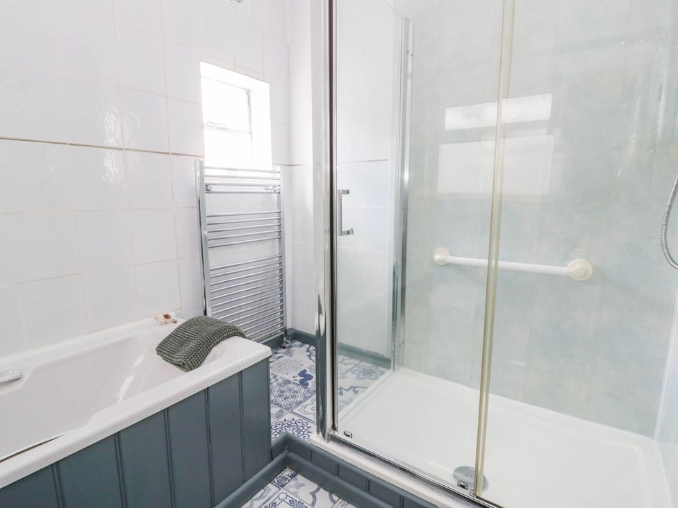 A bathroom with a bathtub and shower at Llain in Cardigan