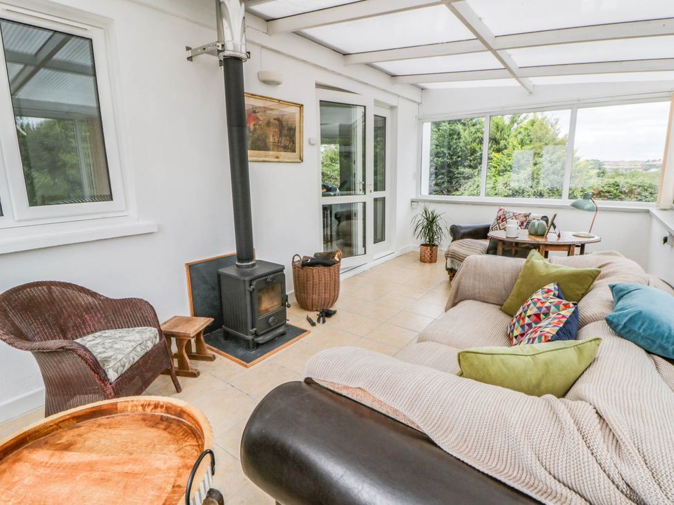 A snug with a sofa and stove at Llain in Cardigan