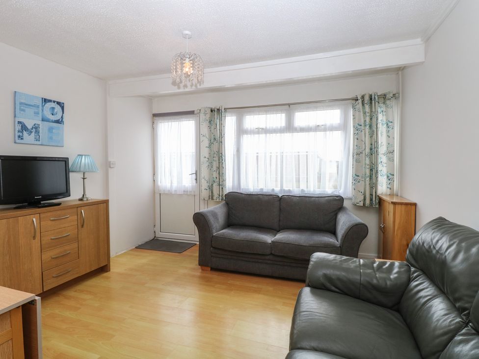 A living room with a sofa and a TV cabinet at 440 California Sands