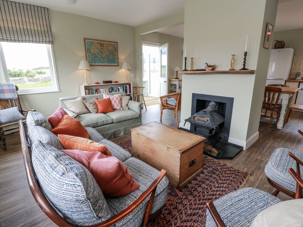 A living room with a sofa and fireplace at The Dairy in Newton Stewart