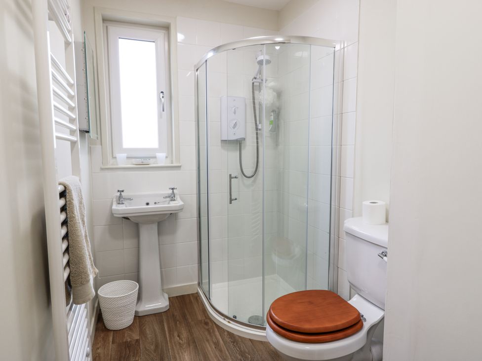 A bathroom with a shower, sink, and toilet at The Dairy in Newton Stewart