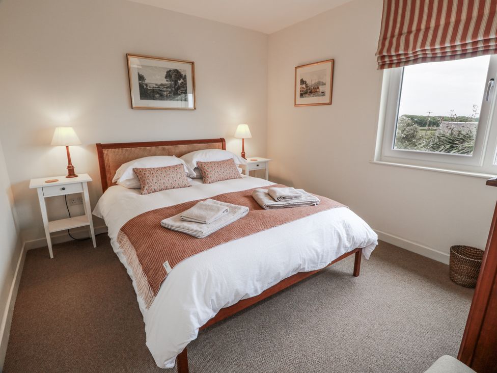 A bedroom with a double bed and bedside tables at The Dairy in Newton Stewart