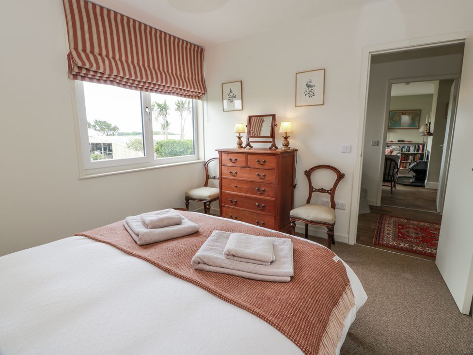 A bedroom with a bed and window at The Dairy in Newton Stewart