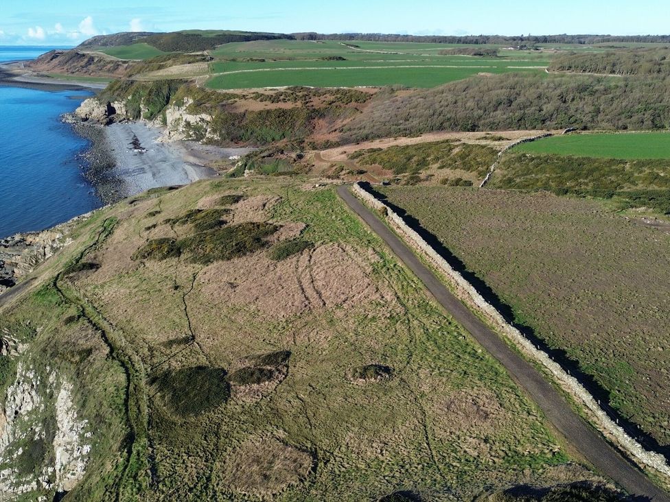 A coastal area with cliffs and ocean at The Dairy in Newton Stewart