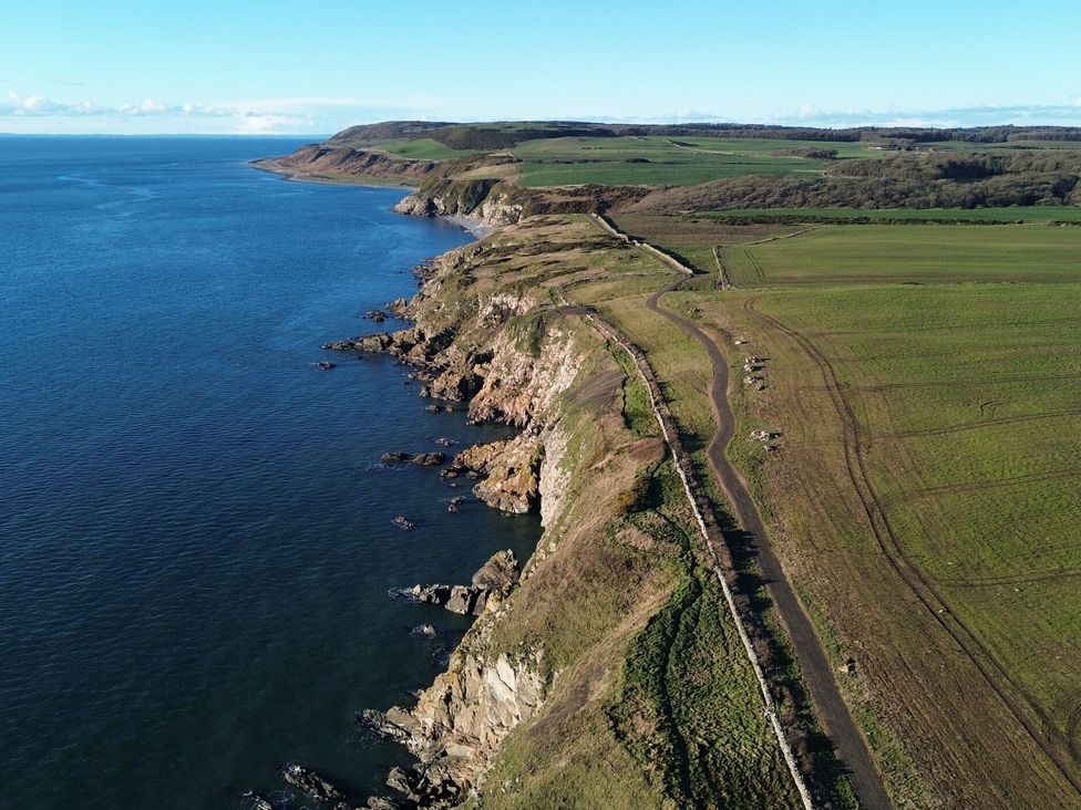 A coastline with cliffs and a road at The Dairy in Newton Stewart