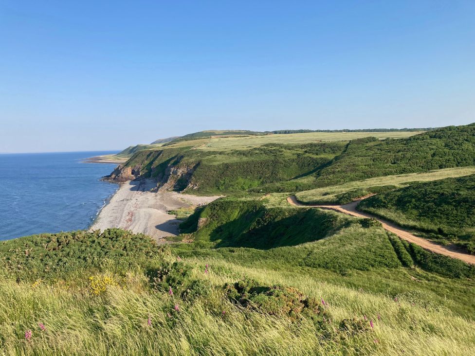 A coastal view with hills and a path at The Dairy in Newton Stewart