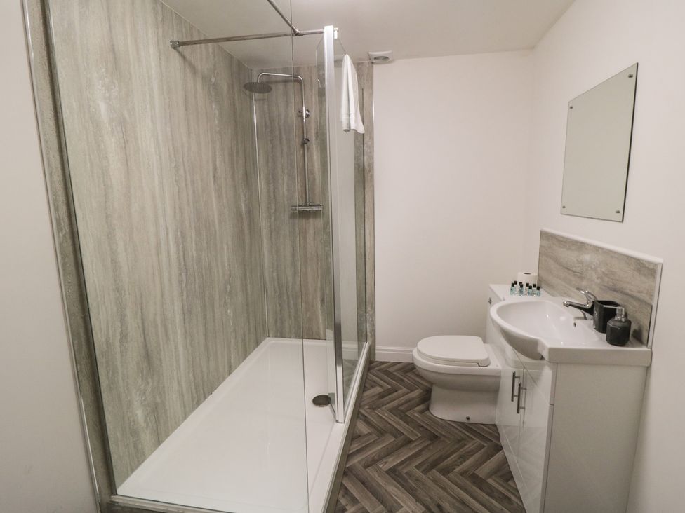 A bathroom with a shower, toilet, and sink at The Newborough Apartment 3 in Scarborough