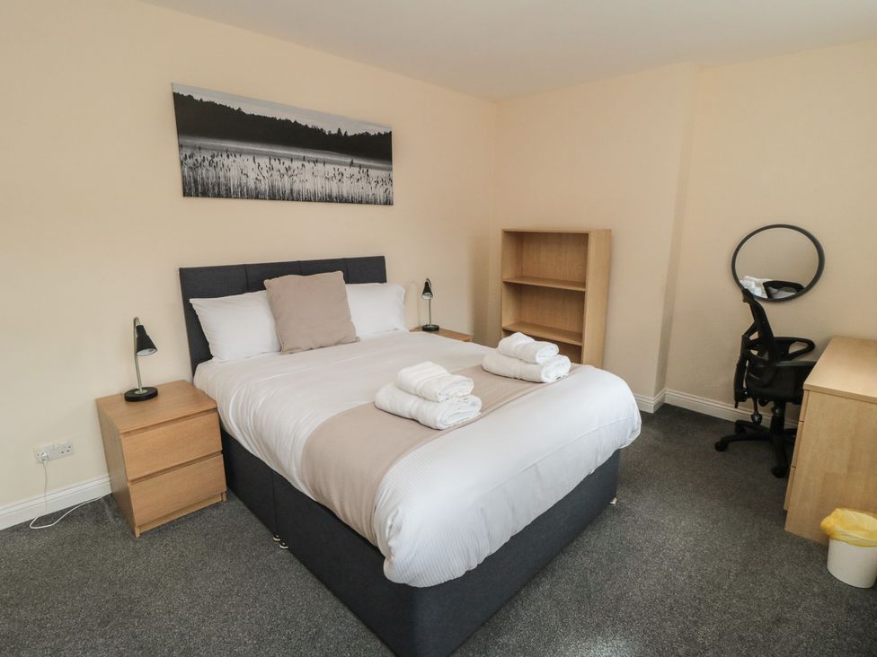 A bedroom with a bed and desk at The Newborough Apartment 3 Scarborough
