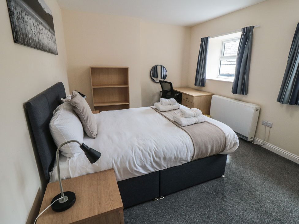 A bedroom with a bed and desk at The Newborough Apartment 3 in Scarborough