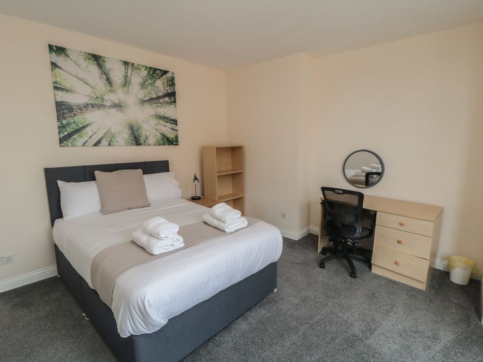 A bedroom with a bed, desk, and chair at The Newborough Apartment 3 Scarborough
