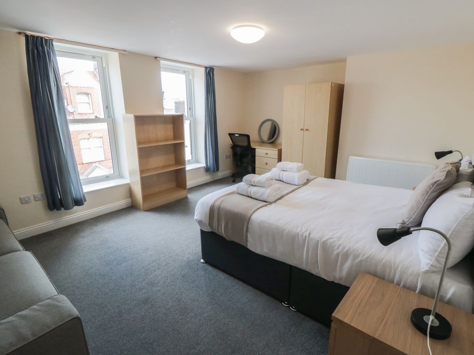 A bedroom with a bed and desk at The Newborough Apartment 4 Scarborough