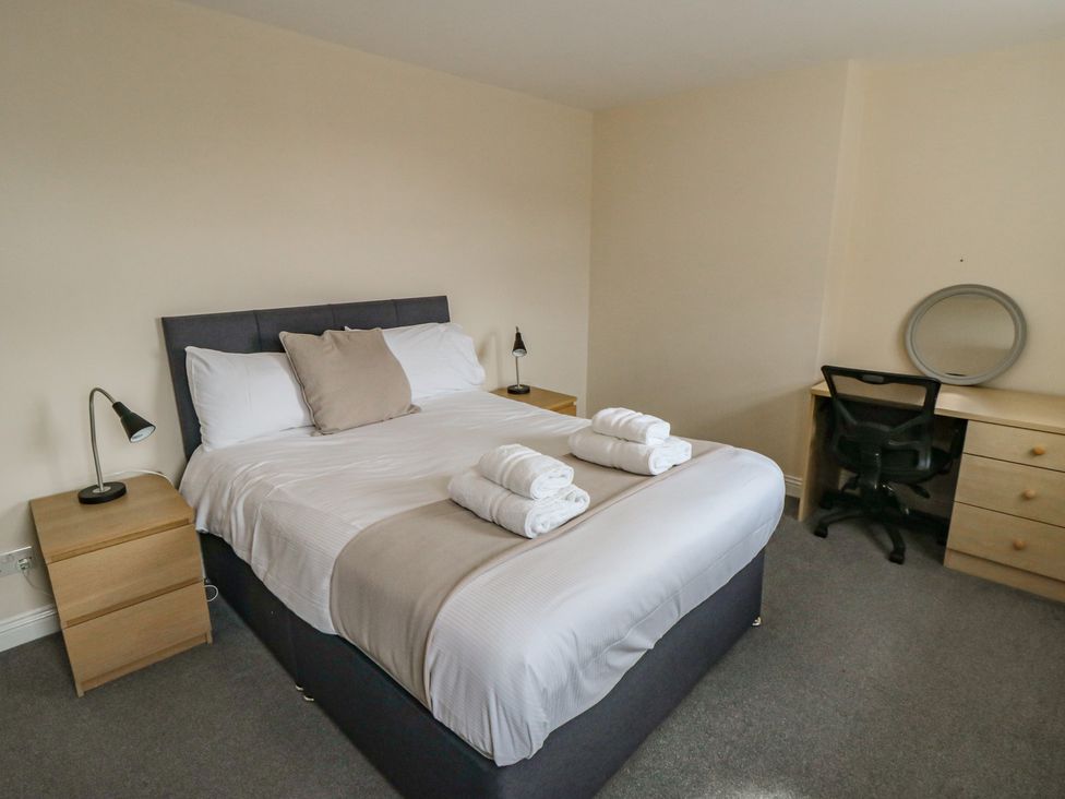 A bedroom with a bed and desk at The Newborough Apartment 4 Scarborough