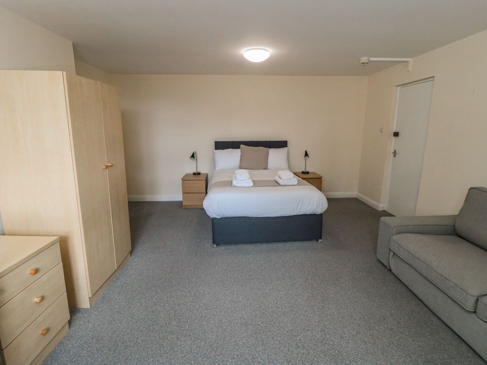 A bedroom with a bed and nightstand at The Newborough Apartment 4 Scarborough