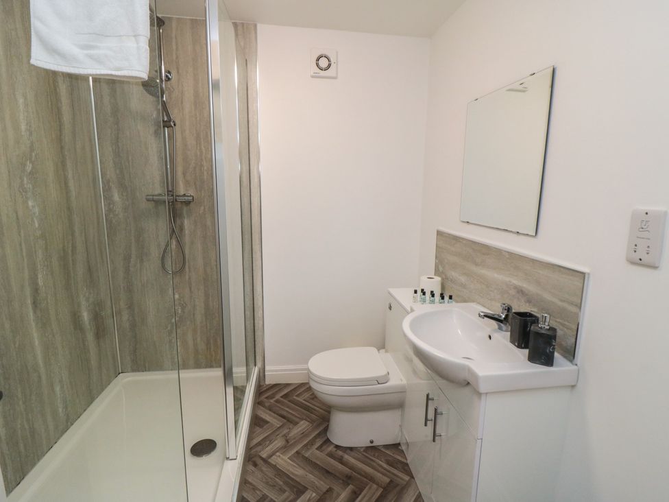 A bathroom with a shower, toilet, and sink at The Newborough Apartment 4 in Scarborough