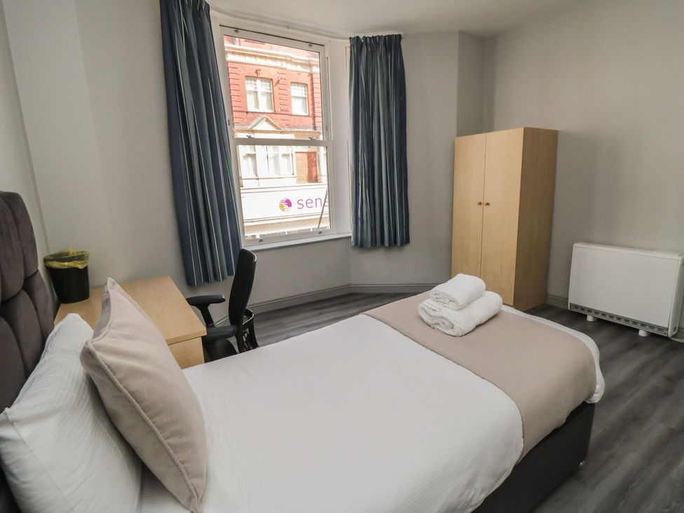 A bedroom with a bed and desk at The Newborough Apartment 2 in Scarborough