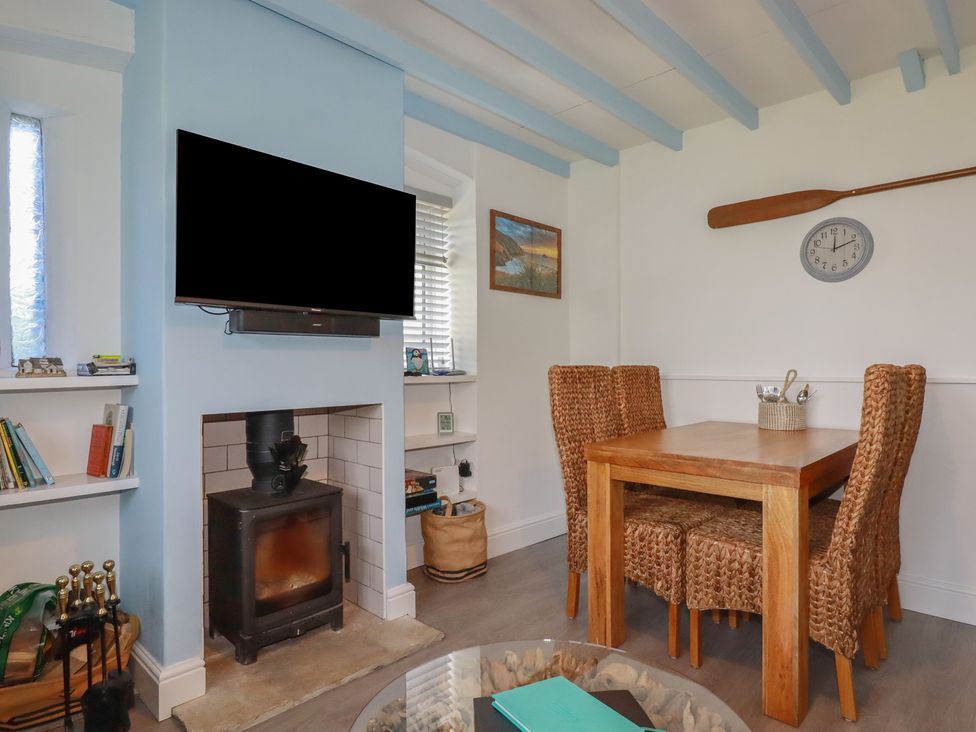 A dining room with a table and chairs at Puffin Cottage Tintagel