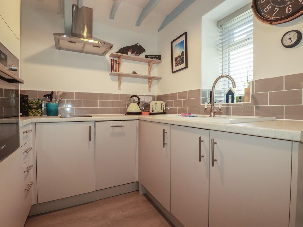 A kitchen with a sink and kettle at Puffin Cottage in Tintagel