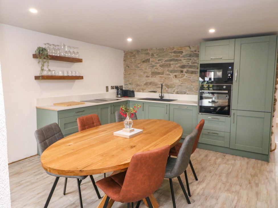 A kitchen with a dining table and chairs at Valley View House Kealkill County Cork