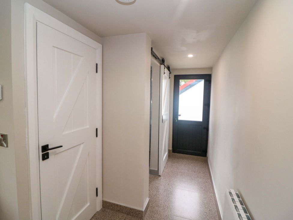 A hallway with doors and light fixtures at Valley View House in Kealkill, County Cork