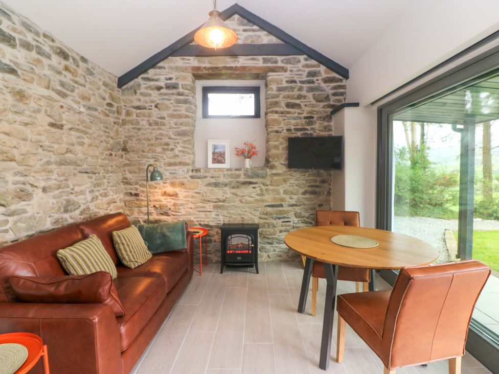 A living room with a sofa and table at The Stall near Kealkill, County Cork