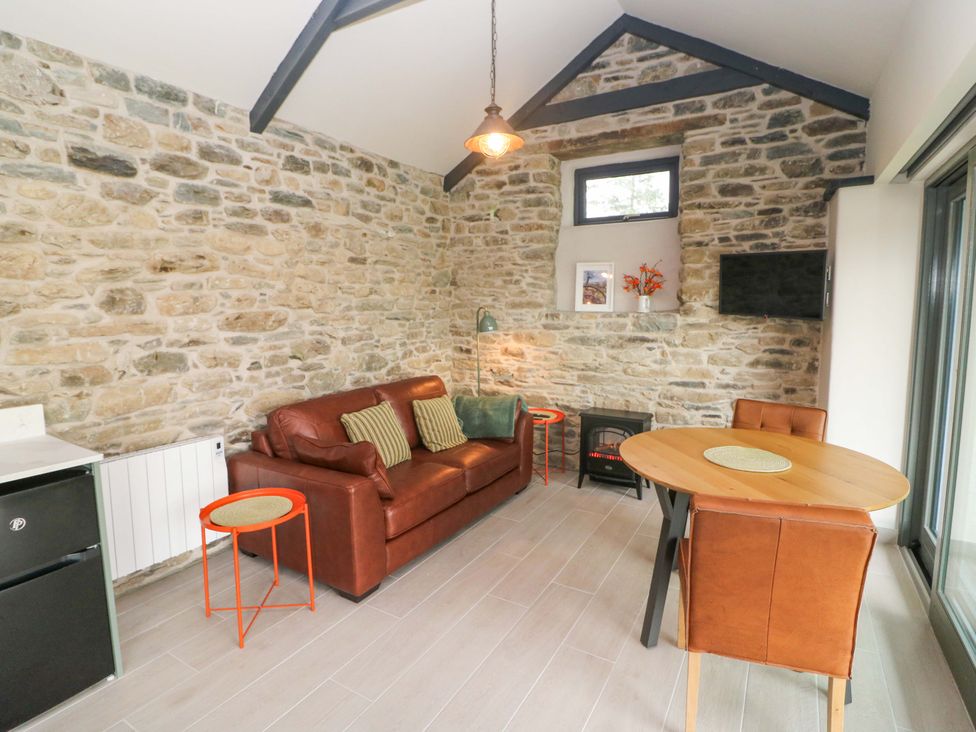 A living room with a sofa and dining table at The Stall near Kealkill, County Cork