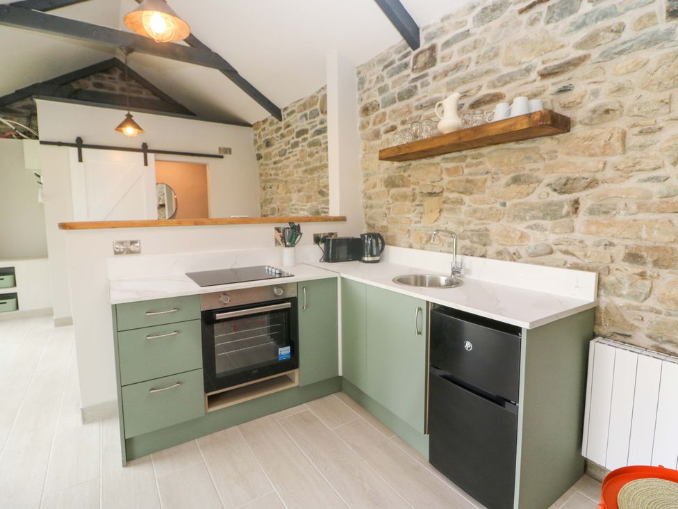 A kitchen with cabinets and appliances at The Stall near Kealkill, County Cork