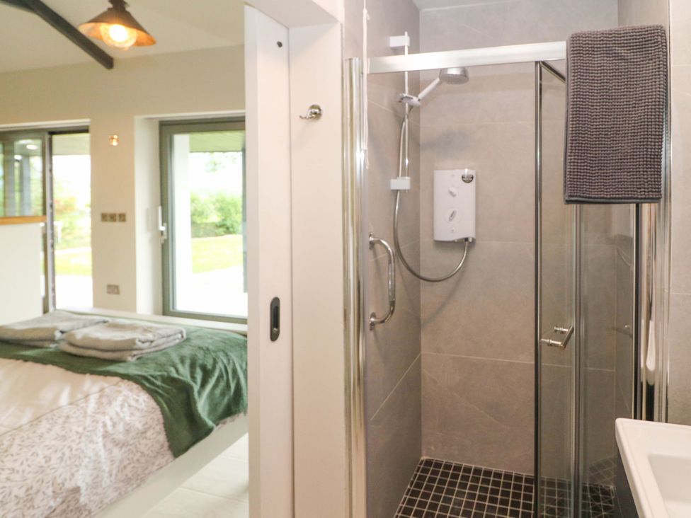 A bathroom with a shower and sink at The Stall near Kealkill, County Cork