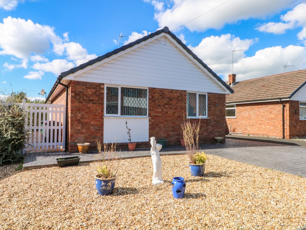 A house with a gravel front garden and a statue at The Warren in Chester