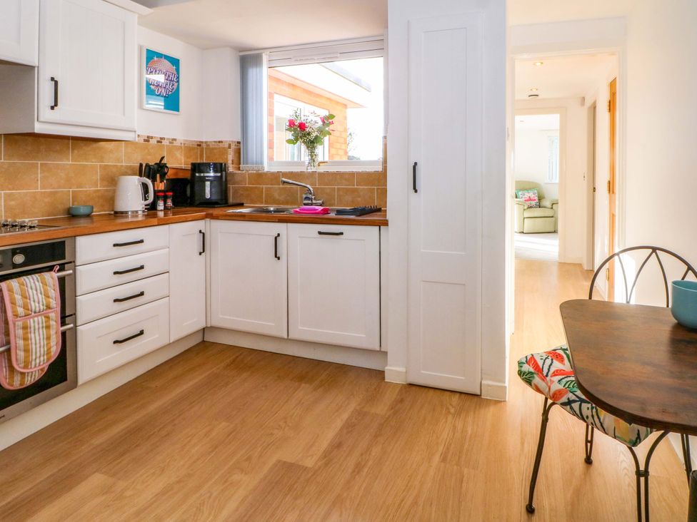 A kitchen with cabinets, countertop, and appliances at The Warren in Chester