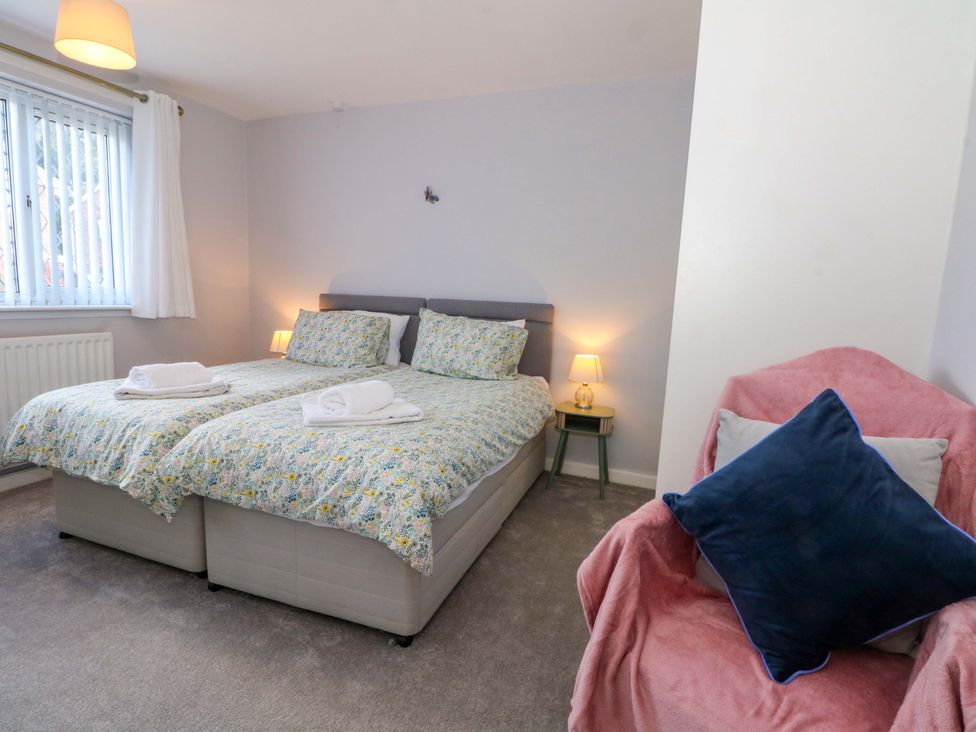 A bedroom with two beds and a chair at The Warren in Chester