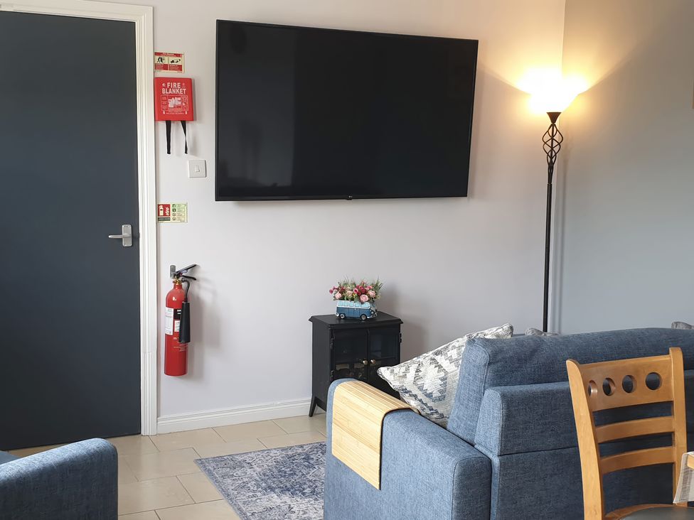 A living room with a television and seating at Shalom Apartment 98B Markethill