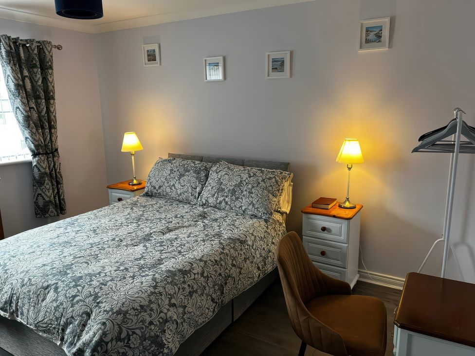 A bedroom with a bed and nightstand at Shalom Apartment 98B Markethill